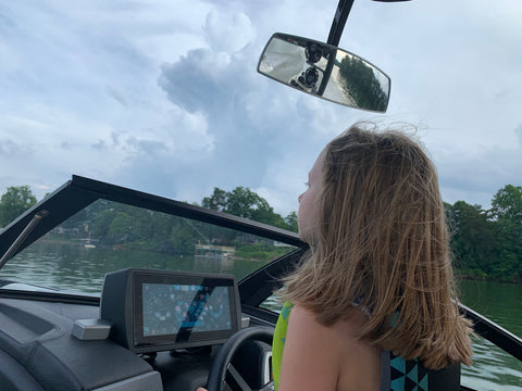 My daughter helping me captain the boat ('When daddy let me drive' surely on the radio)