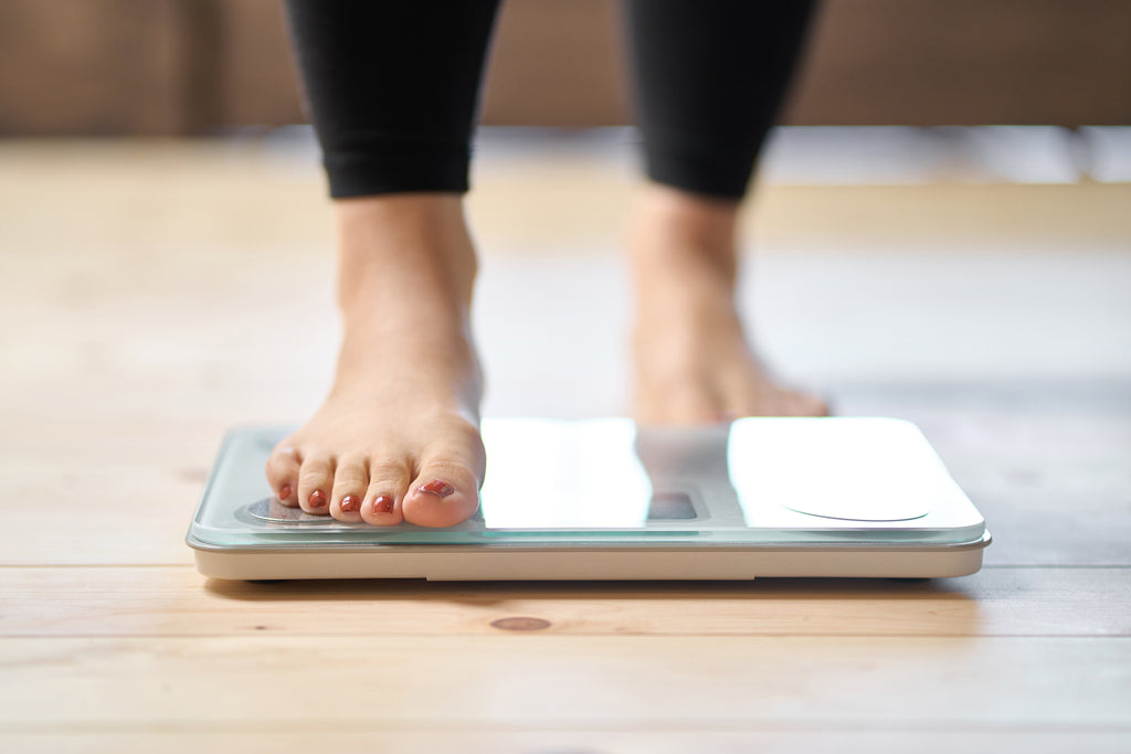 Feet of a woman on a weighing scale