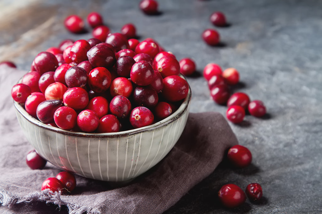 cranberries in a bowl on a table