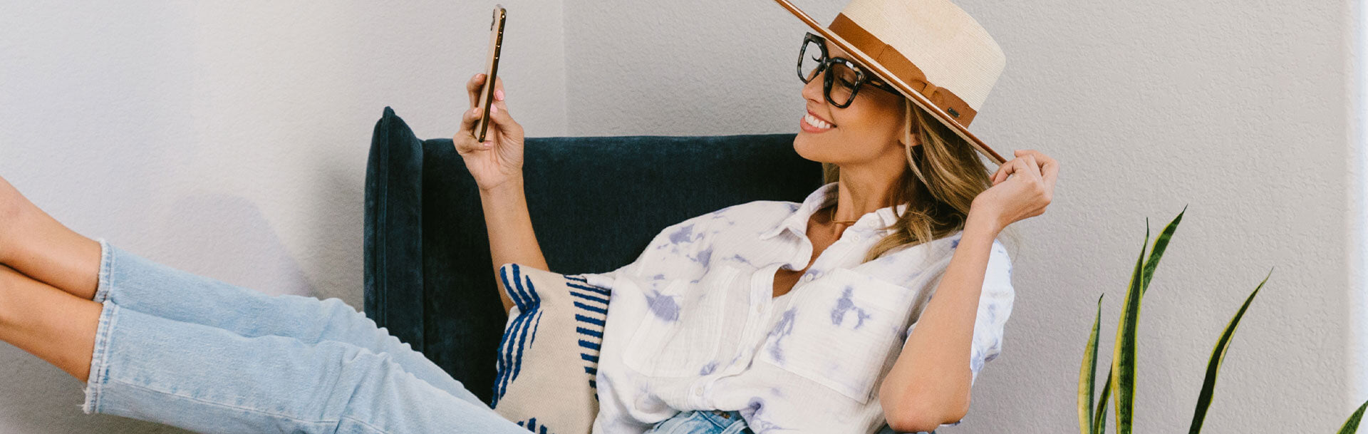 Blonde woman in Next Level looking at phone