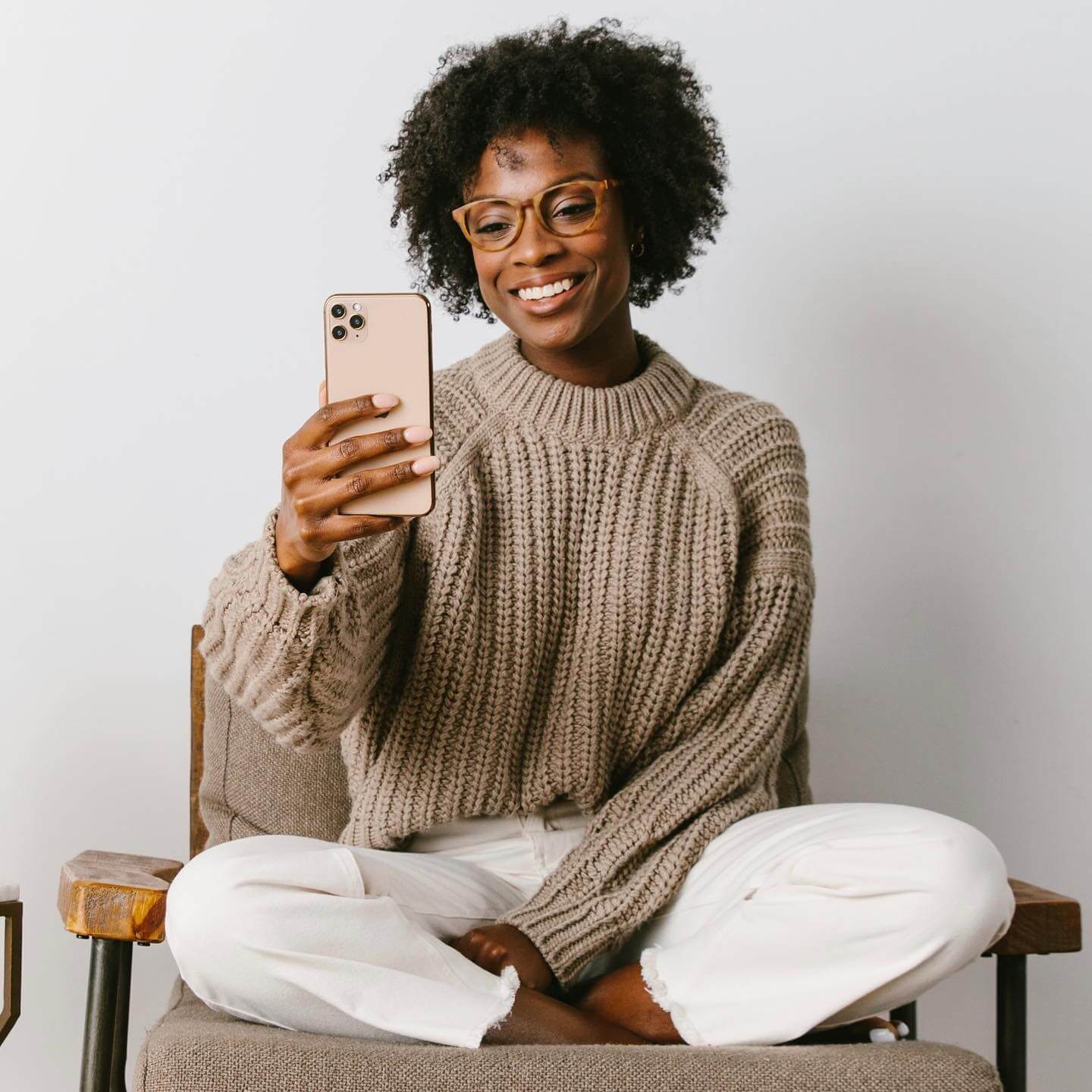 Black haired woman wearing Canyon looking at phone