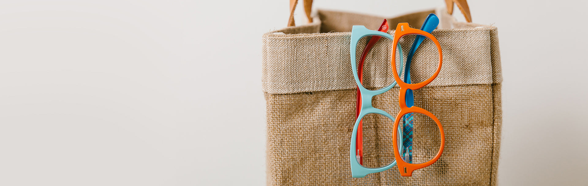 Peepers Reading Glasses Hung Over Side Of Bag
