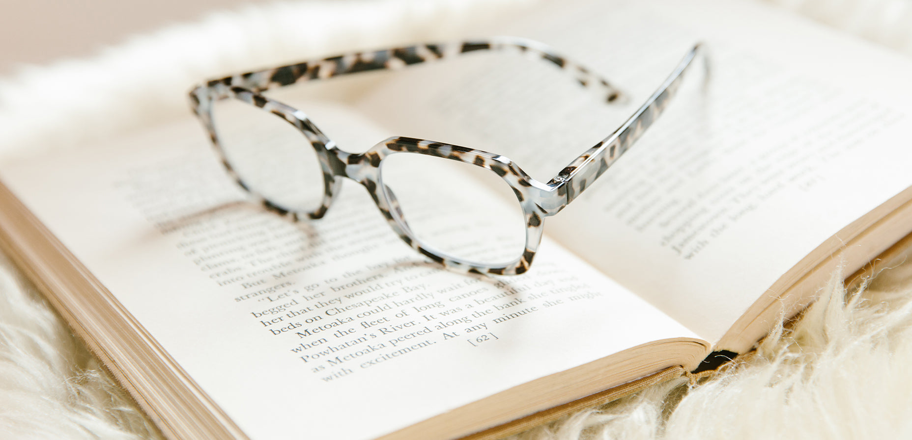 Peepers gray tortoise reading glasses on a book