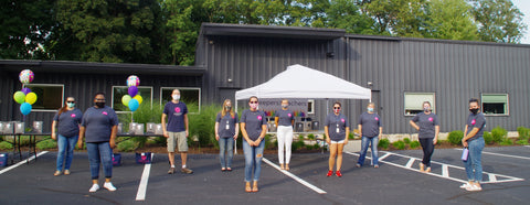 Peepers Standing in Peepers Headquarters Parking Lot During Peepers For Teachers Donation Event