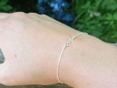 Woman wearing a sterling silver triangle bracelet