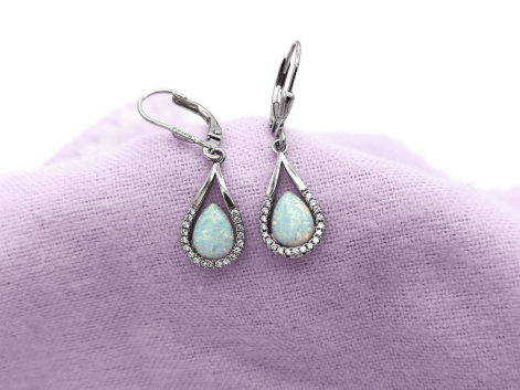 silver pear cut opal drop earrings on a purple napkin