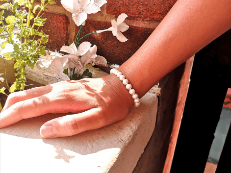 woman wearing a beaded pearl bracelet