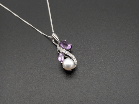 Silver amethyst pearl & cz necklace on a black background