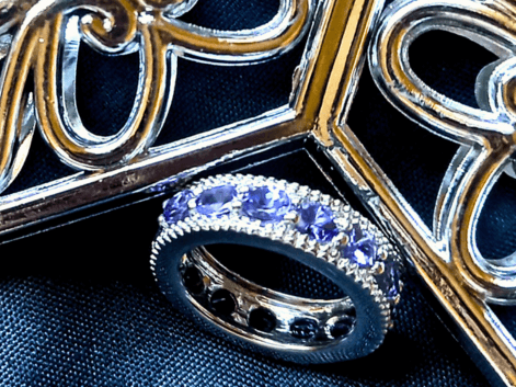 tanzanite eternity ring on a black background