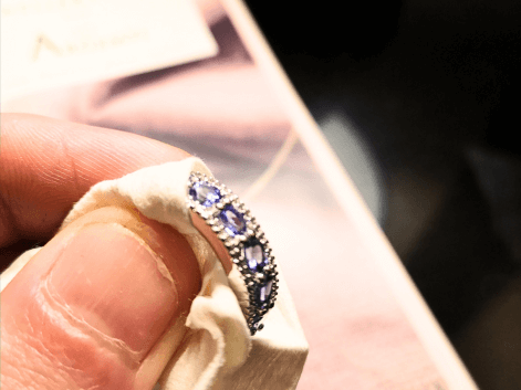 tanzanite eternity ring being cleaned by a jeweller