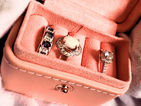 silver gemstone rings in a pink ring box
