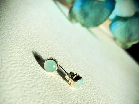 Aquamarine stud earrings on a white table