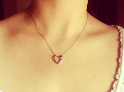 woman wearing a rose gold and cz heart necklace