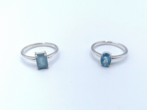 Two aquamarine rings on a white background