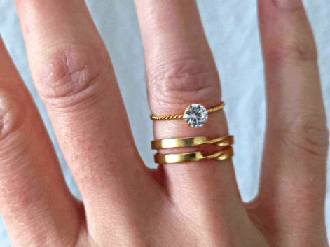Woman wearing a stack of gold rings