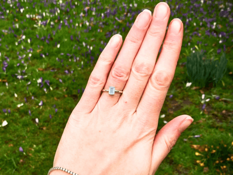 Woman wearing an emerald cut aquamarine ring