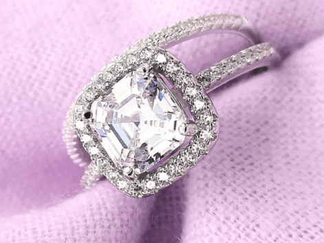 asscher cut diamond halo engagement ring and a diamond eternity ring on a purple napkin.png__PID:2a35f1a4-9bd2-4b51-ab87-1283f800b087