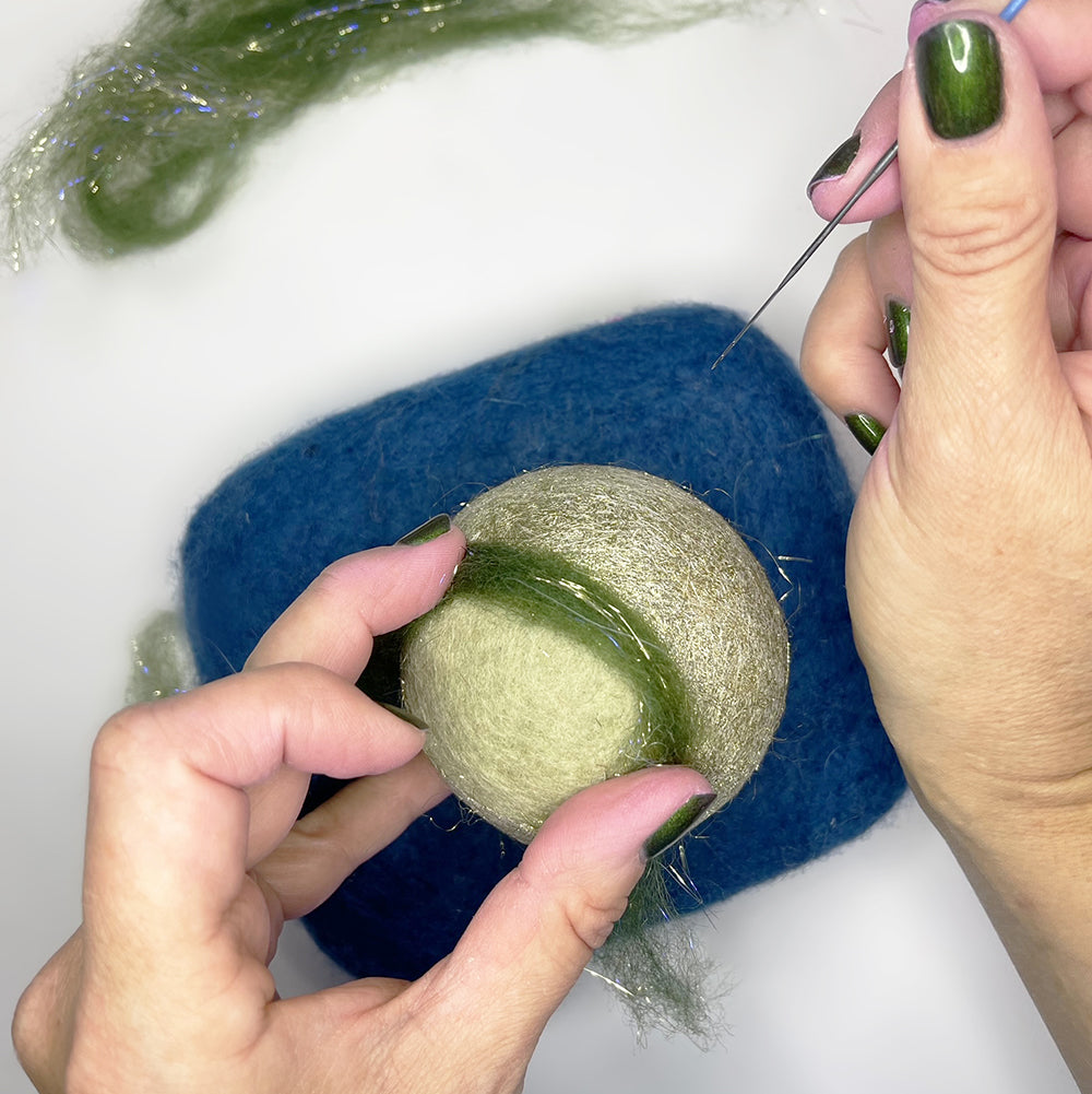 Needle felting roving into pom