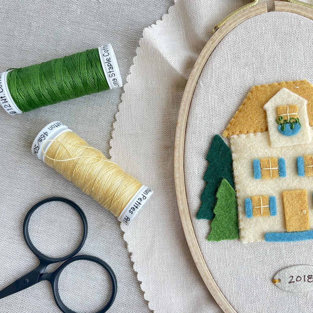 Stitching house onto embroidery hoop