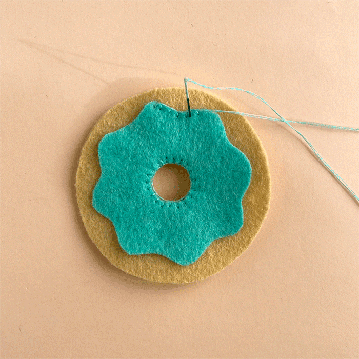 Stitching glaze onto felt donut