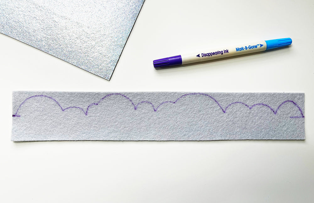 Drawing cloud pattern on metallic felt