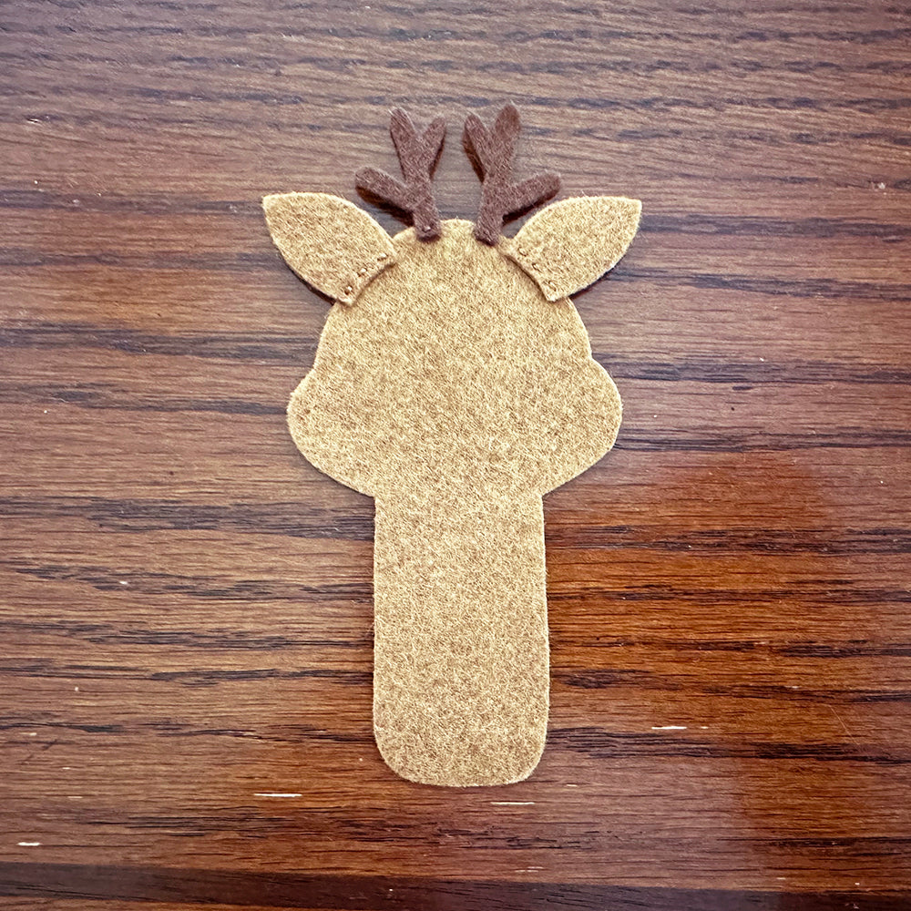 Stitching ears and antlers to reindeer