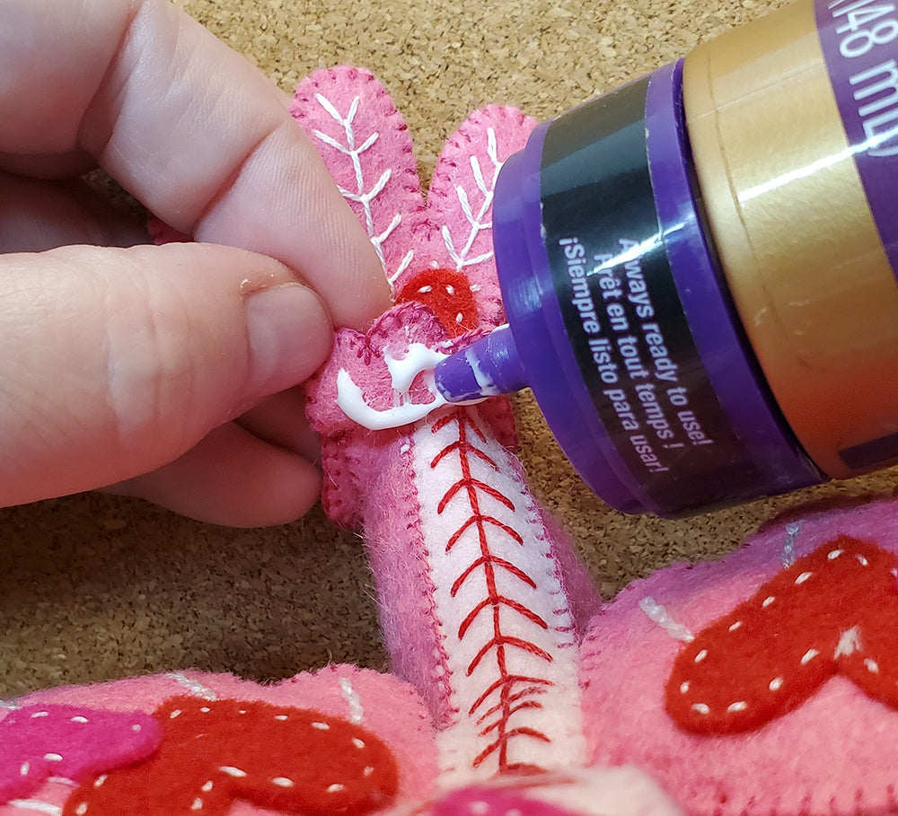 Adding tail to stuffed bird