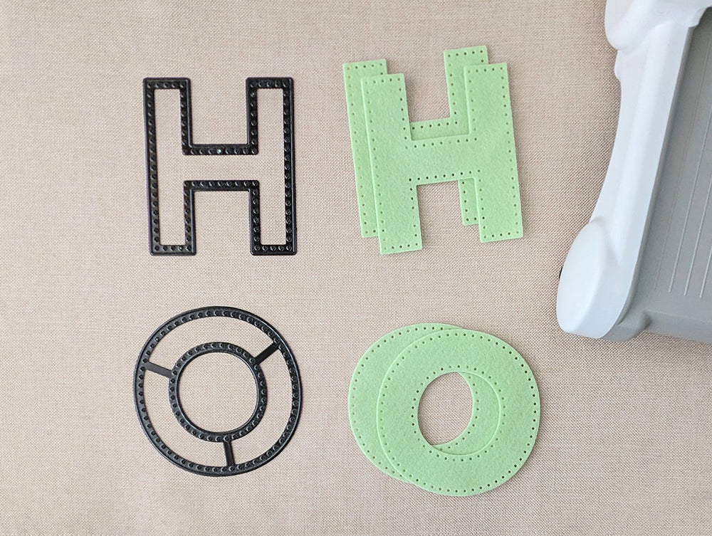 Cutting two of each letter from felt