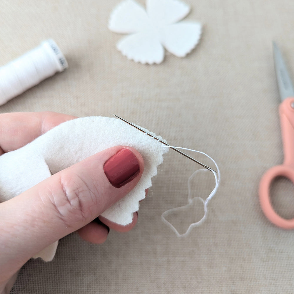 Tucking thread ends into stitching