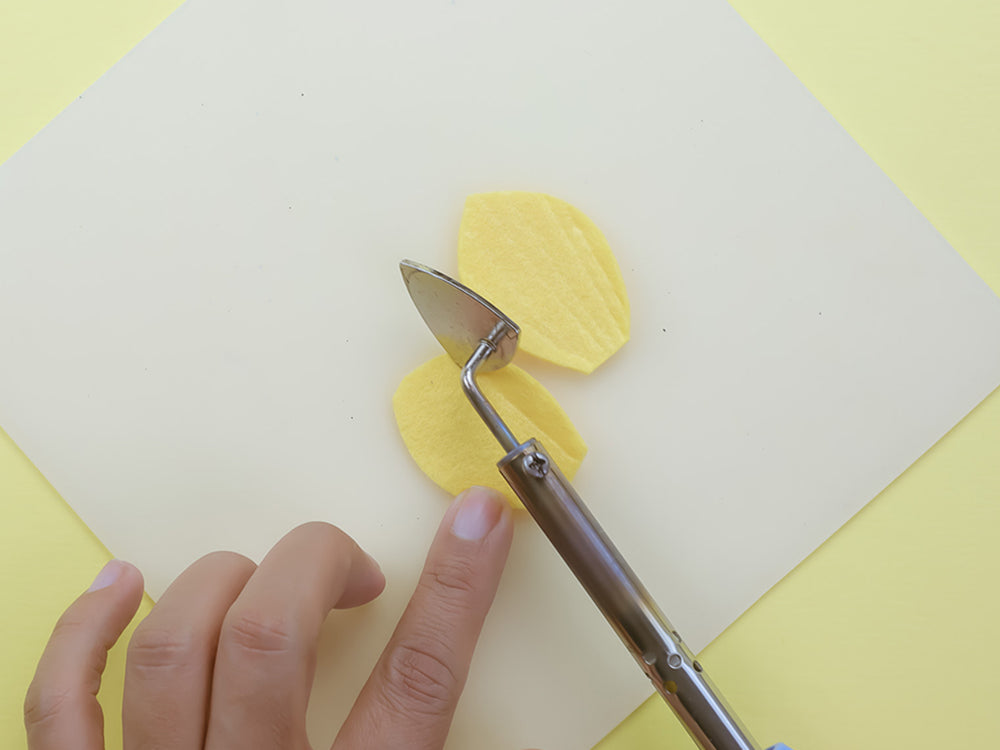 Ironing creases into felt petals