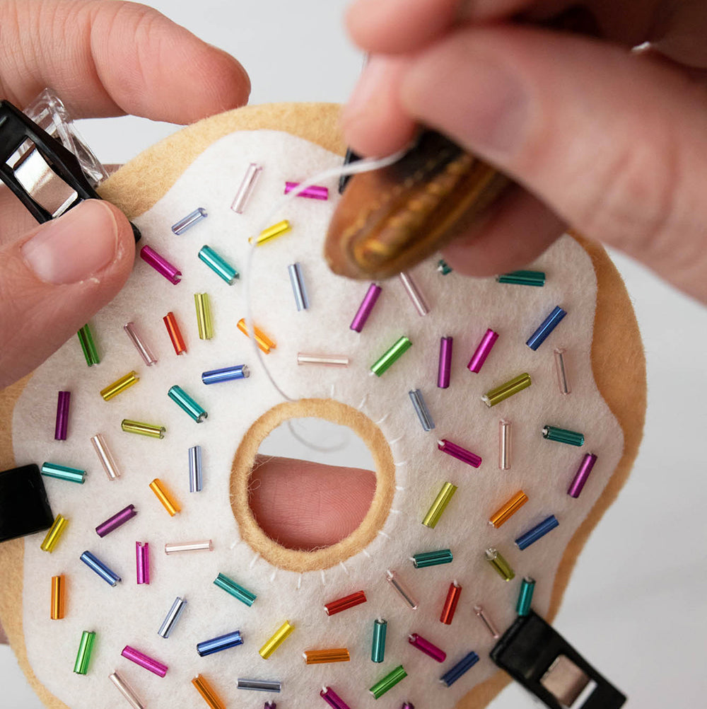 Whip stitch embellished frosting to donut