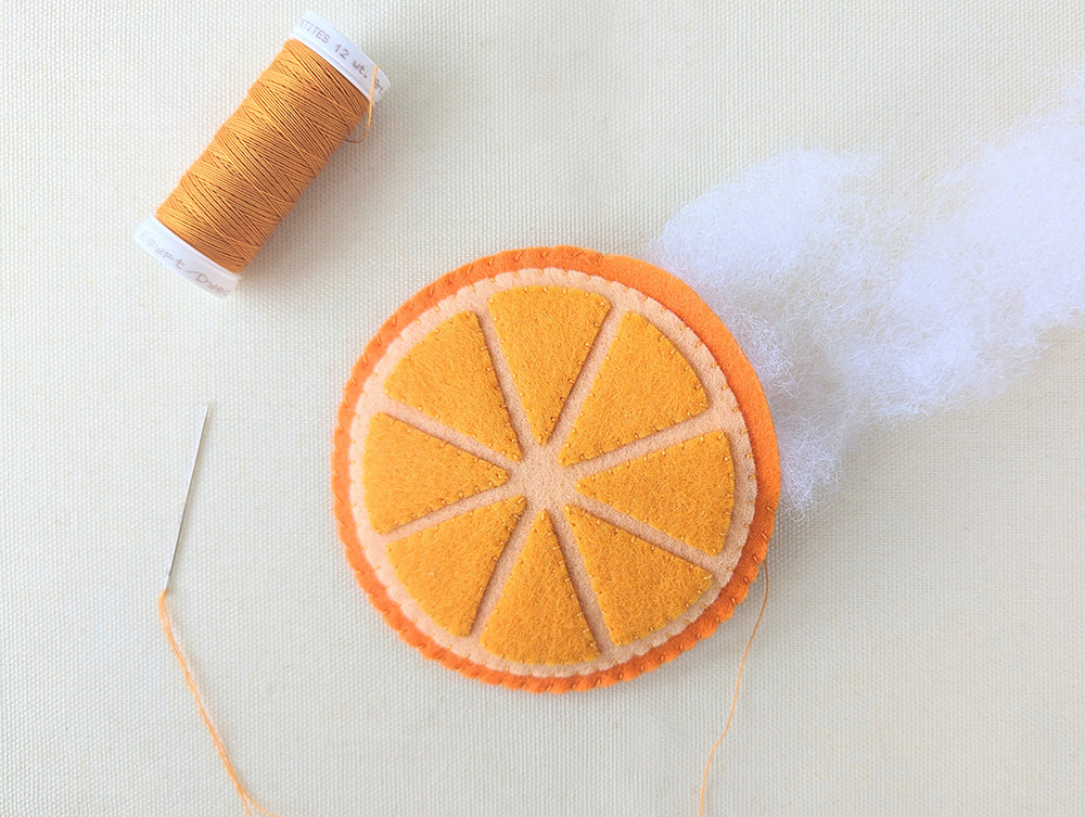 Stuffing and stitching orange closed