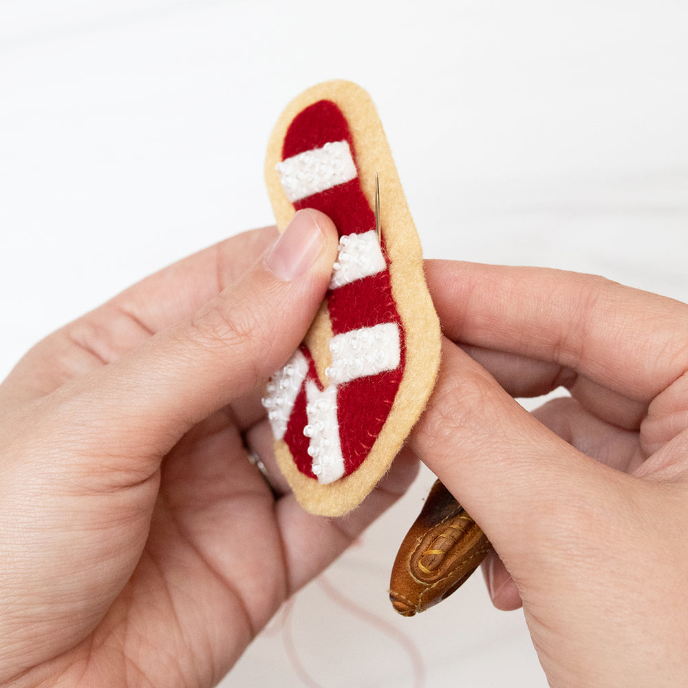 Stitching candy cane to cookie top