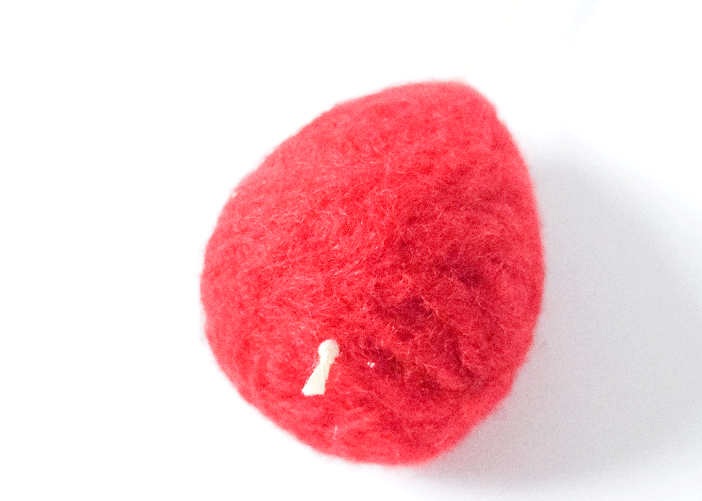 Stitching a felt strawberry