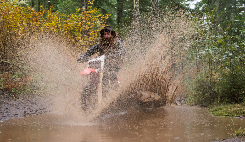 riding through puddle, waxed canvas, seth neefus, honda dirt bike, honda cr125, red clouds collective, dirt bike