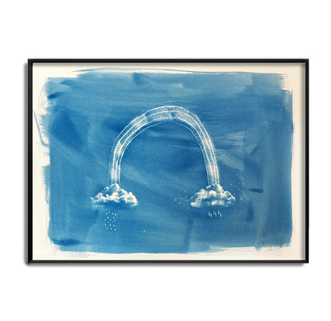 Craig Keenan a Cyanotype artist has printed a blue print of a rainbow with clouds in a black frame