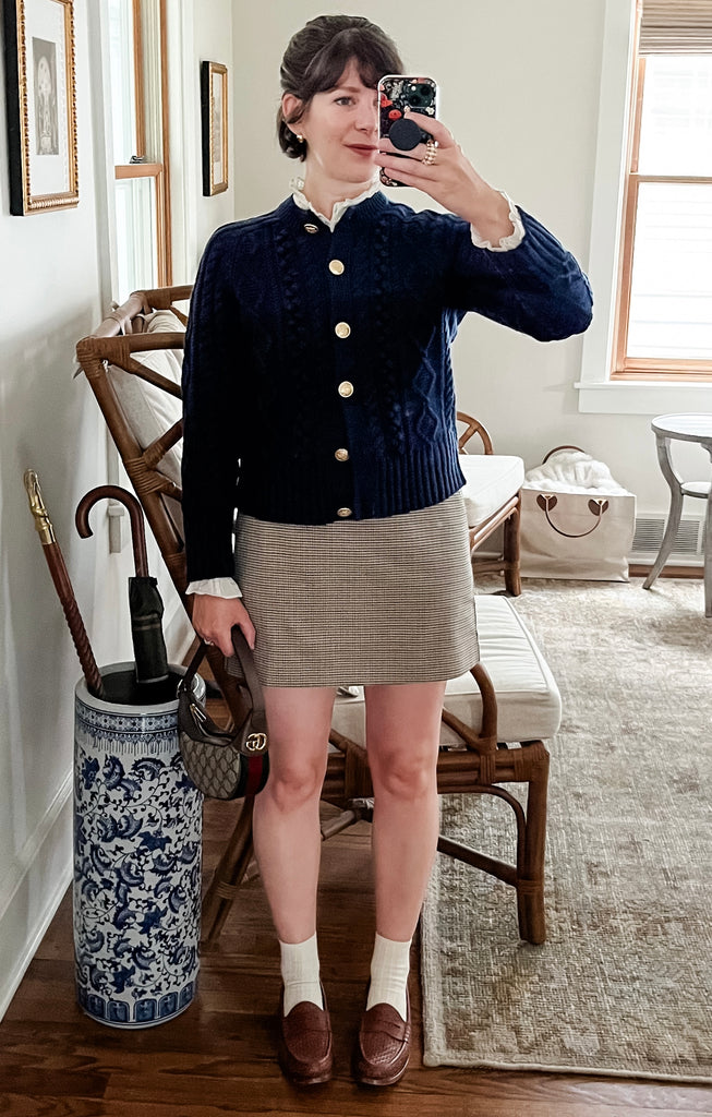 Maria Confer wearing a J Crew cable knit cardigan and Mango houndstooth mini skirt with penny loafers and a Gucci Ophidia bag