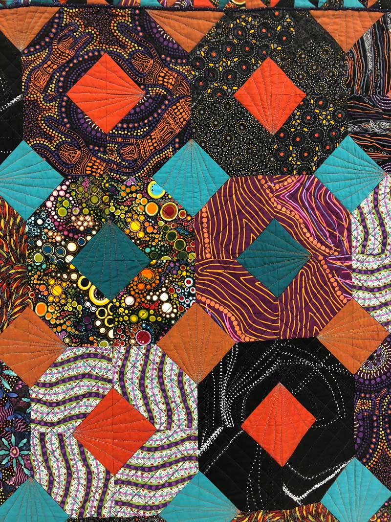 Detail, “The Unexpected Visitor Goes Walkabout” quilt by Jane Butckovitz