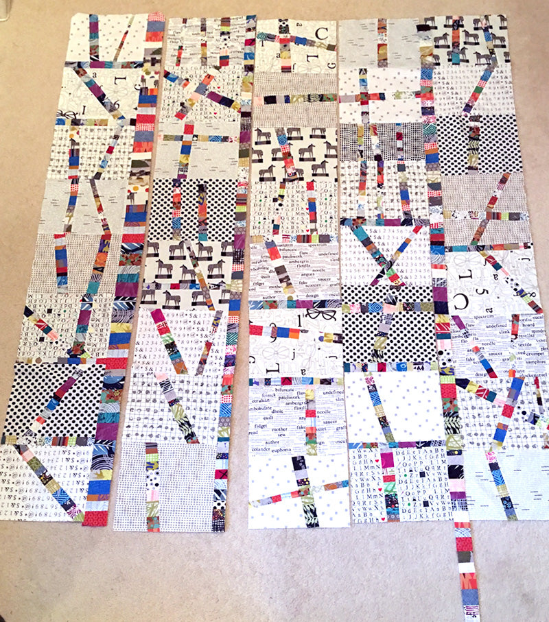Adding vertical strips to the finished blocks for the final quilt design