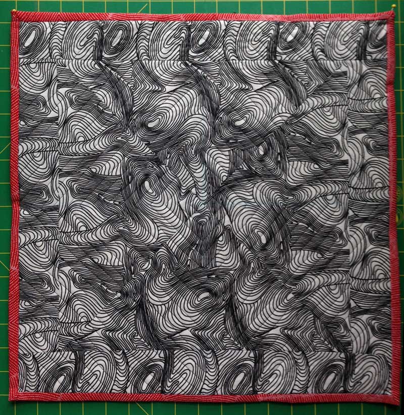River Dreaming Black fabric pieced into pillow by Christine Vinh, StitchesnQuilts