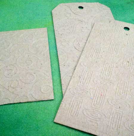 Plain chipboard, die cut into shapes and embossed with texture