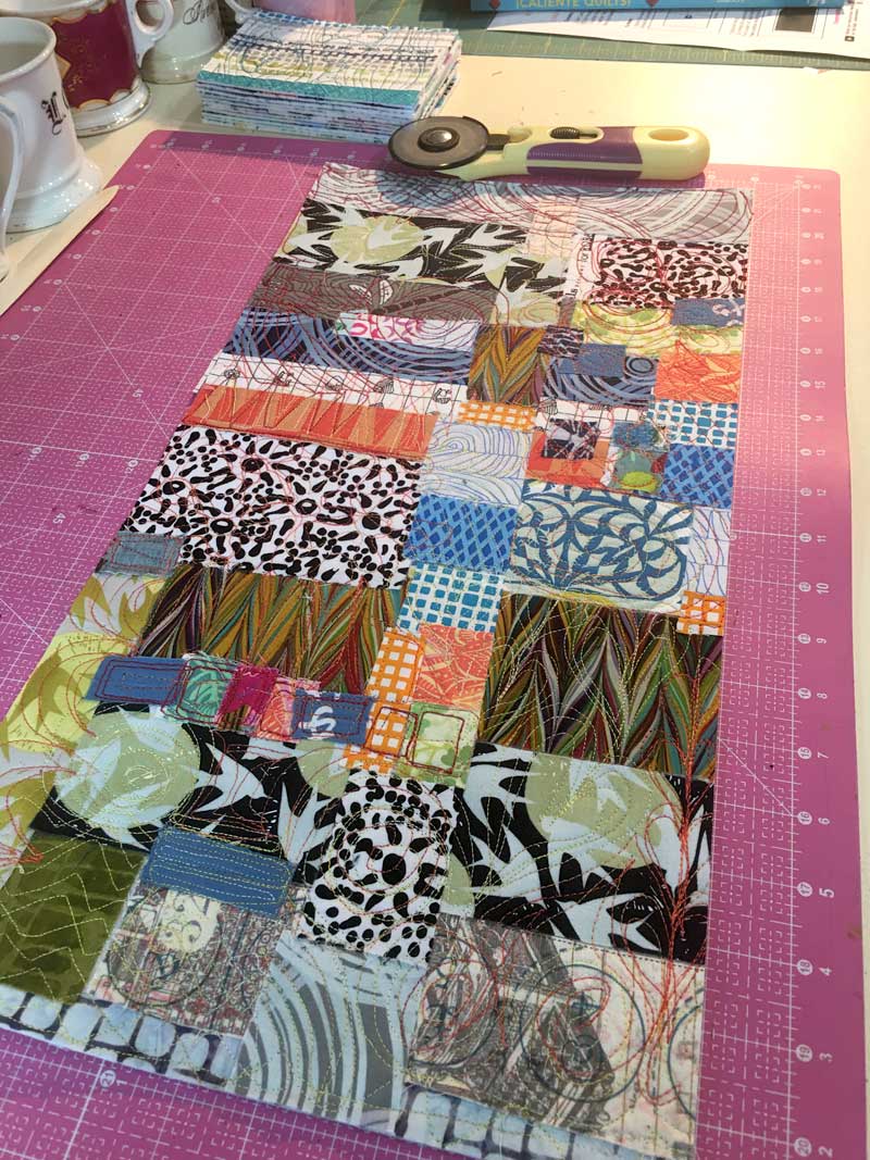 Fabric collaged sheet ready to be cut into postcards