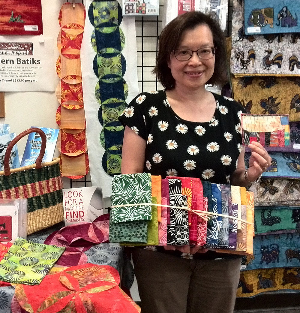 Sue Lee with her Batik Tambal Exclusive Batik fabric prize for being the first to turn in a completed Row by Row Experience quilt.