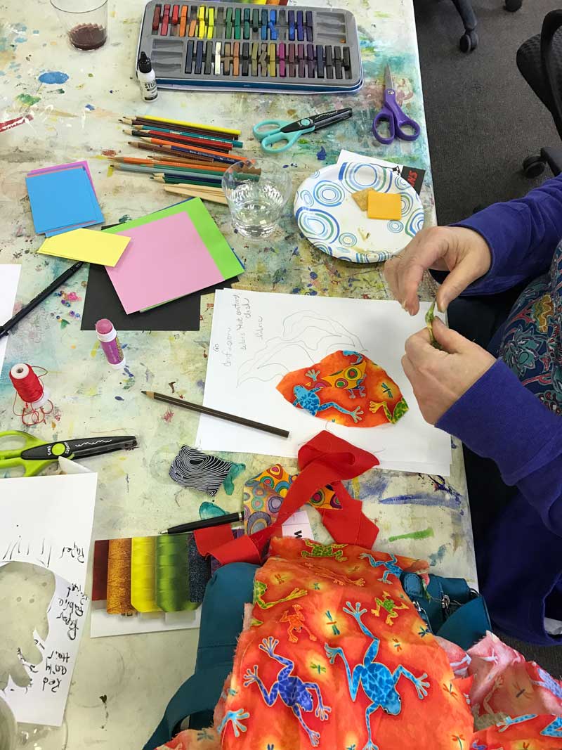 Cutting paper and fabric and using a variety of color tools during the Finding Your Voice lecture/class with Kay Capps Cross