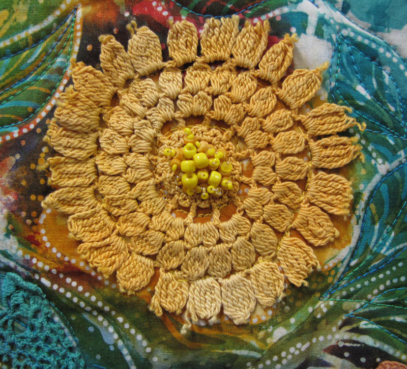 Yellow beads in the center of a doily create a flower