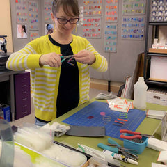 Karyn making earrings in her art studio.