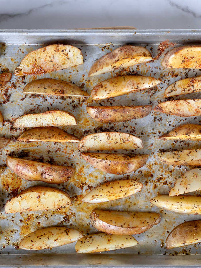 Crispy savory seasoned potato wedges recipe is a crowd pleaser! Serve these with creamy dipping sauce or basic ketchup - yum! #potatorecipes #savory