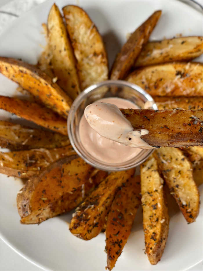 Crispy savory seasoned potato wedges recipe is a crowd pleaser! Serve these with creamy dipping sauce or basic ketchup - yum! #potatorecipes #savory