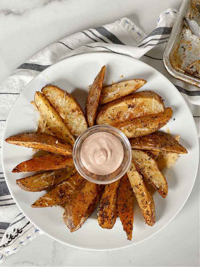Crispy savory seasoned potato wedges recipe is a crowd pleaser! Serve these with creamy dipping sauce or basic ketchup - yum! #potatorecipes #savory