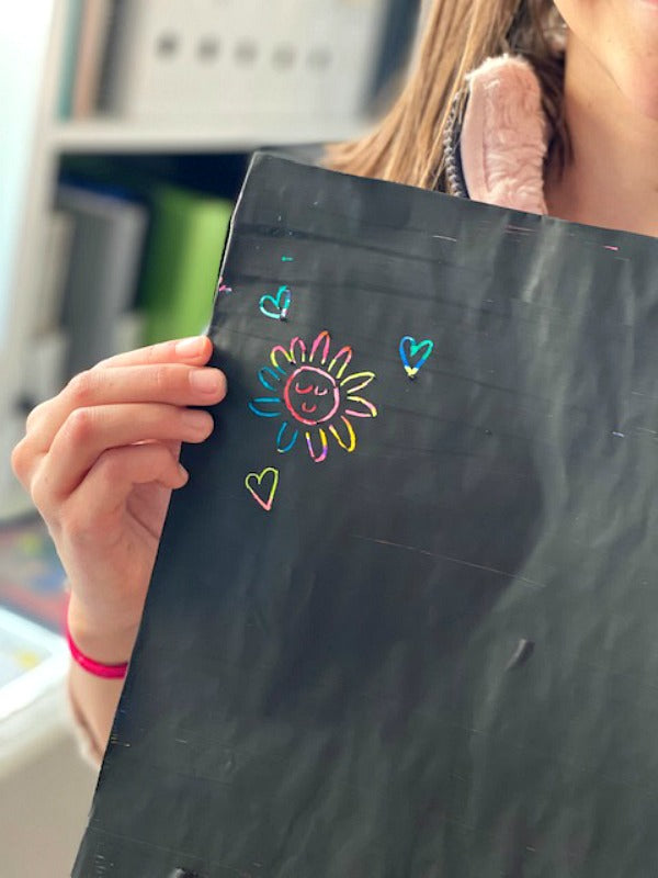 DIY rainbow scratch art is super fun and easy! Little artists make their own canvas and then have fun scratching creative designs. #processart #homeschool #artprojects #covid19 #artforartsake 